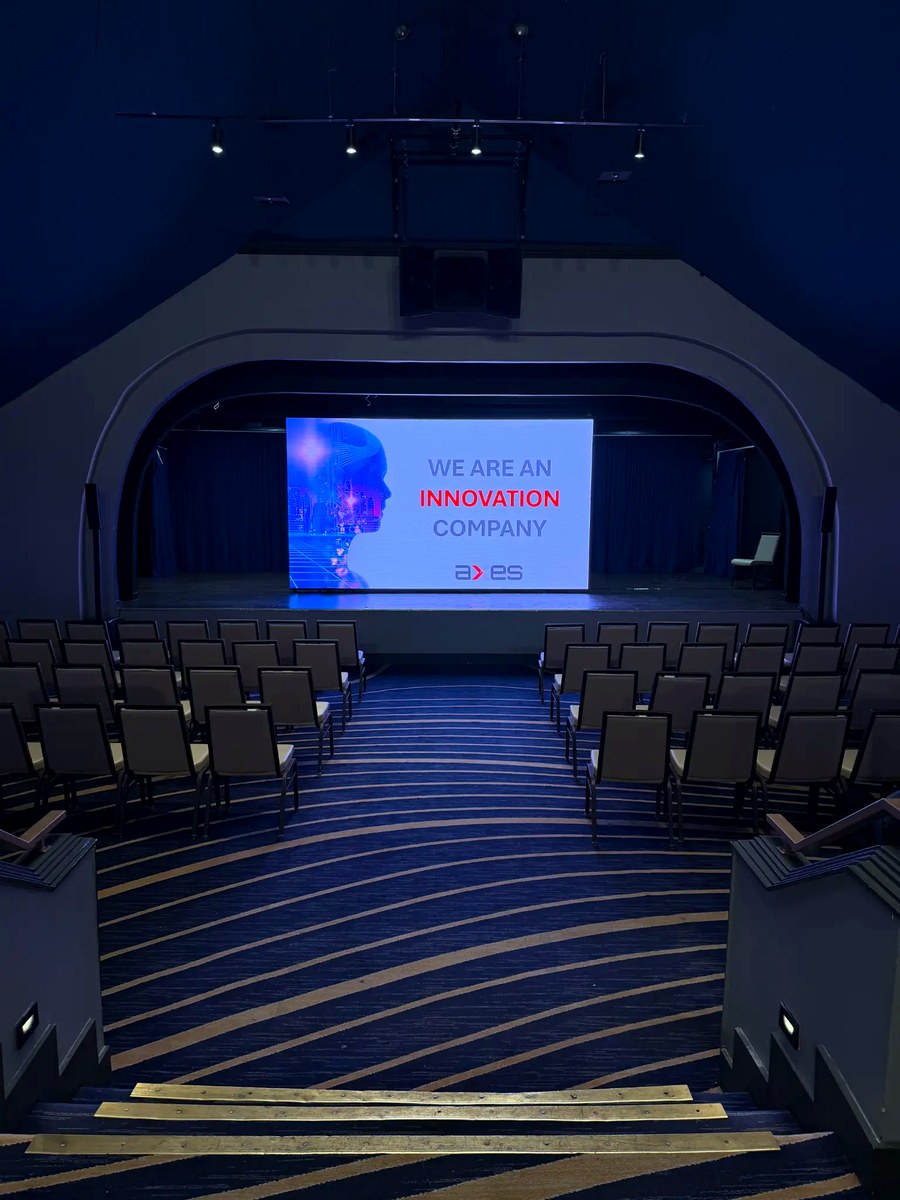 "We Are an Innovation Company" — the AXES brand statement projected on the main stage.