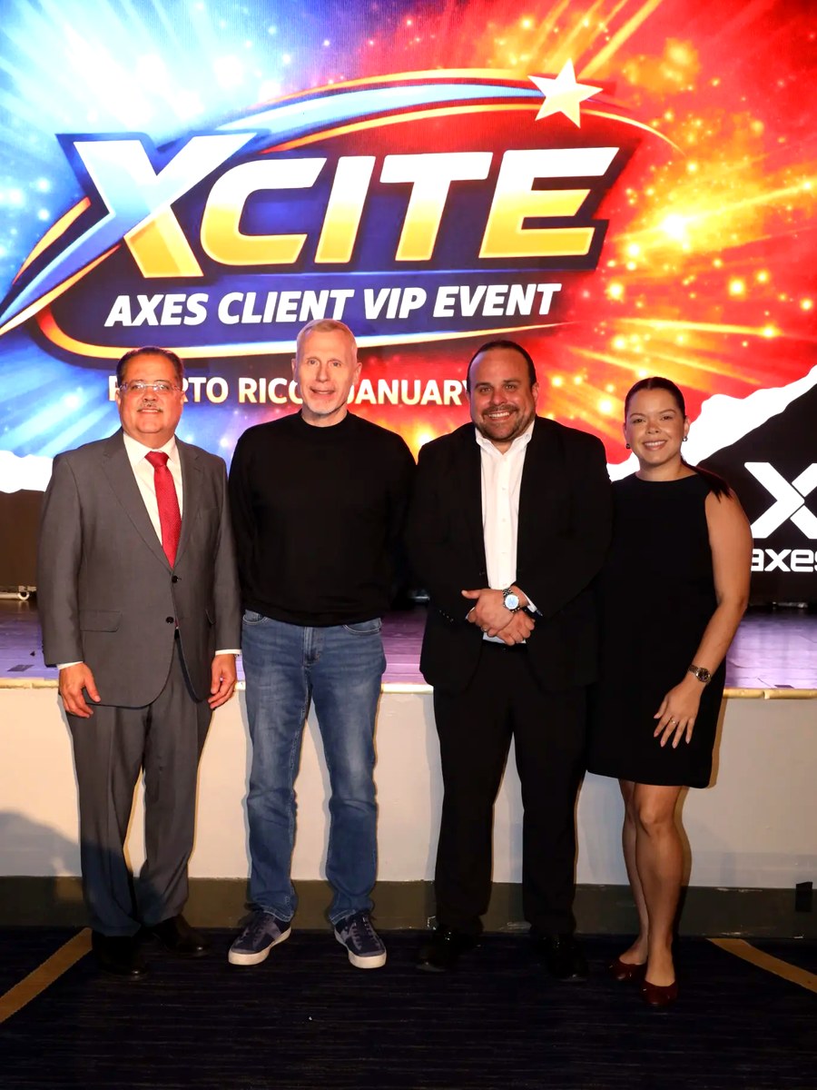 AXES leadership and key partners in front of the XCITE Puerto Rico backdrop.