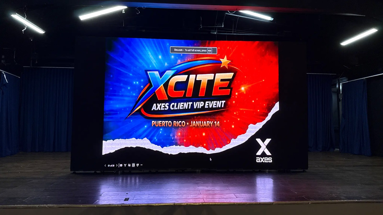 The XCITE Puerto Rico title screen — AXES VIP EVENT · January 14 — projected on the main stage before doors opened.